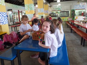 Waiting for her teacher in the canteen.