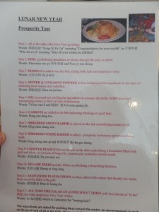 Prosperity Toss: Tradition that involves playing with your food! Mixing shredded veggies, sauces and raw fish together by way of "throwing" the food up high with chopsticks. Maggie Lou got right in on the action.
