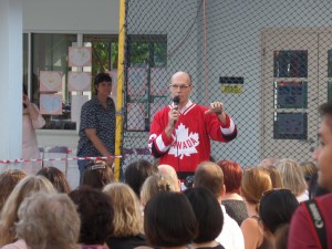 Principal Hoff introducing the parade - and reveling in USA Canadian Hockey wins!