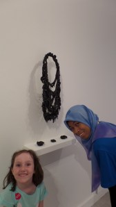 Maggie and a visitors guide - chatting it up about this piece - costume jewelry dipped in black enamel.
